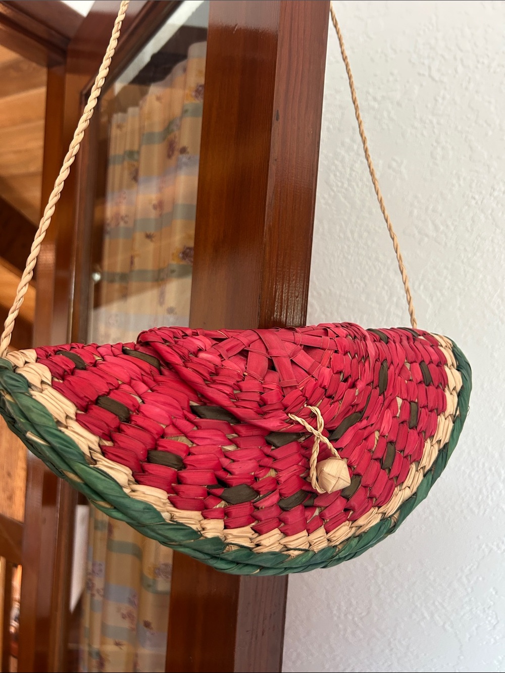 Mexican-made watermelon basket purse, handwoven from natural palm leaf fibers.